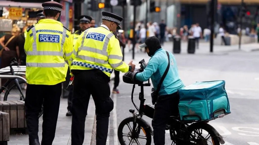 Policier londonien contrôlant un vélo électrique avec un dynamomètre portable en bord de route à Londres