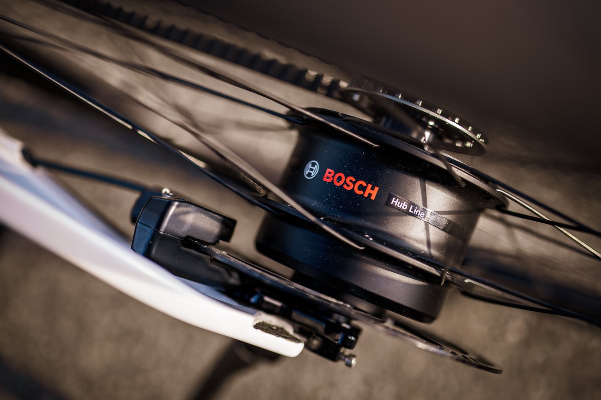 Moteur Bosch Hub Line noir intégré au moyeu arrière d'un vélo électrique à transmission par courroie
