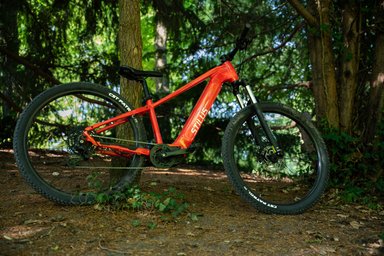 Decathlon Stilus Offroad+ rouge, VTT électrique semi-rigide 29 pouces testé par Cleanrider, vue de profil sur chemin