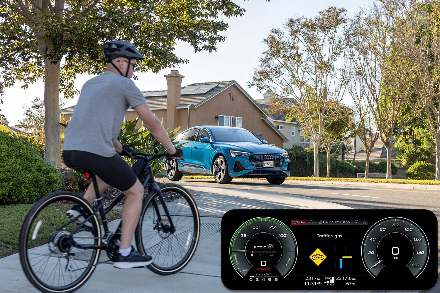 Voiture Audi équipée de la technologie C-V2X détectant un cycliste à proximité pour améliorer la sécurité en ville.